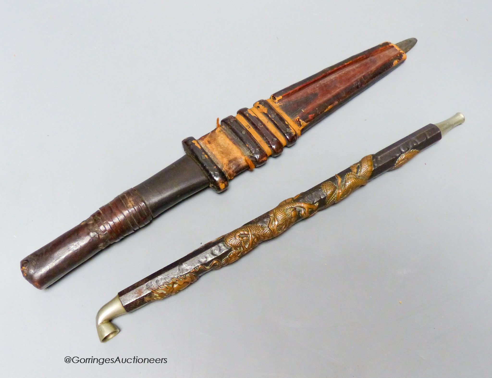 A Japanese dragon decorated bronze and mixed metal tobacco pipe, 31cm and a dagger